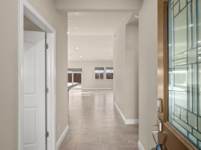 hallway featuring light tile patterned floors