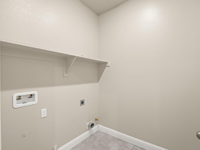 laundry area featuring hookup for an electric dryer, hookup for a gas dryer, hookup for a washing machine, and light tile patterned floors