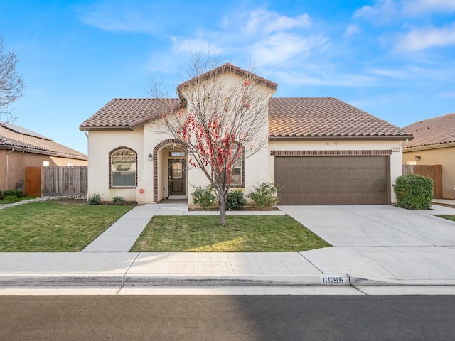 mediterranean / spanish-style home with a garage and a front lawn