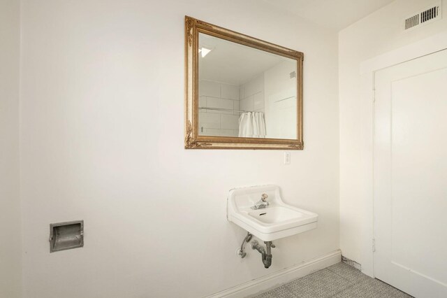 bathroom with tile patterned flooring, sink, and a shower with shower curtain