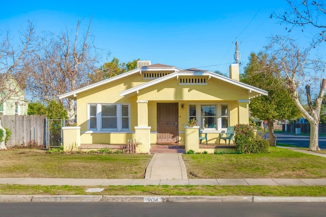 bungalow-style house featuring a front yard and covered porch