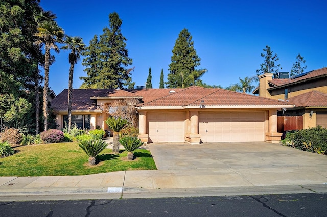 view of front of house featuring a garage and a front lawn