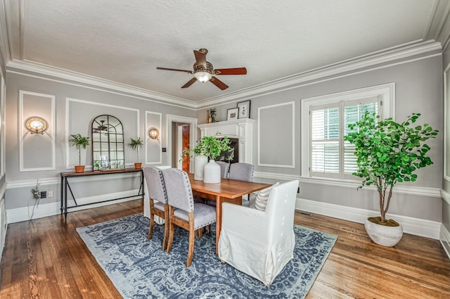 dining room featuring crown molding, dark wood-type flooring, and ceiling fan