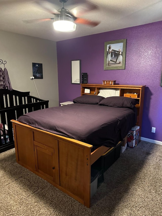 carpeted bedroom featuring a textured ceiling and ceiling fan