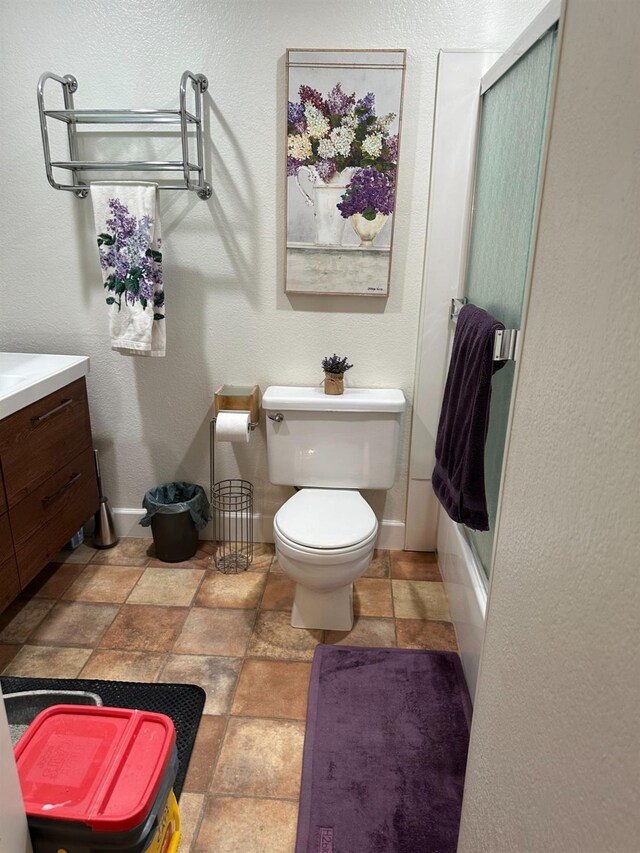 full bathroom featuring vanity, toilet, and combined bath / shower with glass door