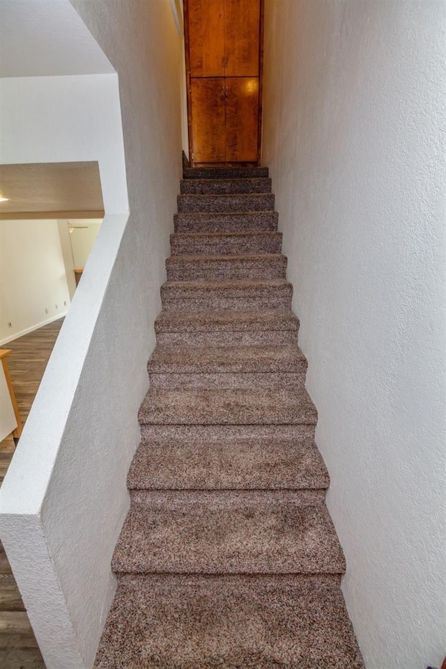 stairs featuring wood-type flooring