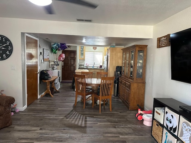 dining area with dark wood-type flooring and sink