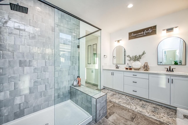 bathroom with vanity and tiled shower