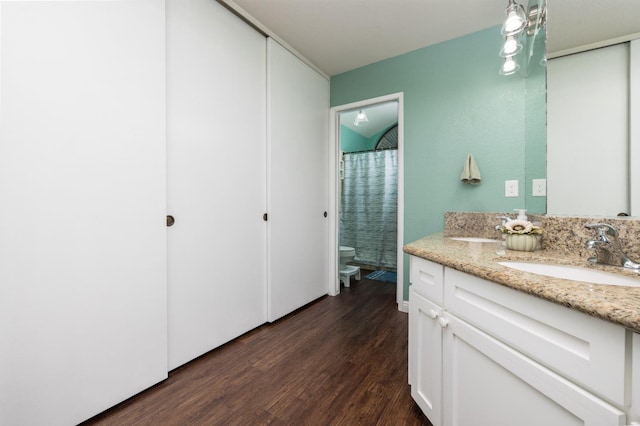 bathroom featuring vanity, hardwood / wood-style flooring, a shower with curtain, and toilet