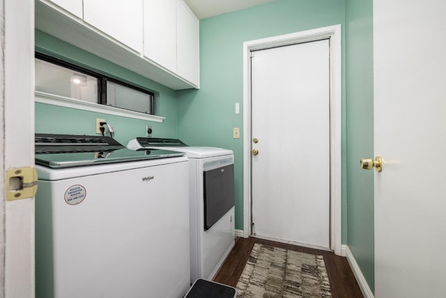 laundry room featuring cabinets, dark hardwood / wood-style floors, and washer and clothes dryer