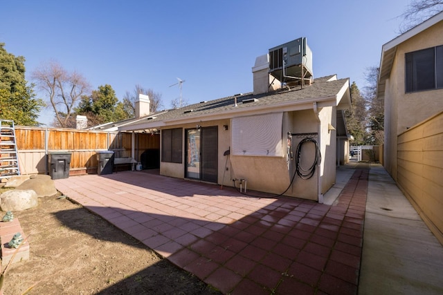 rear view of property with a patio and central AC unit