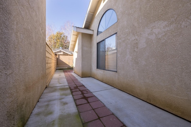 view of side of home with a patio area