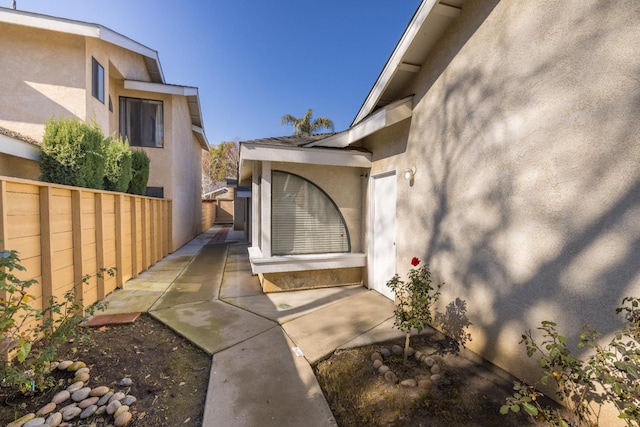 view of exterior entry with a patio area