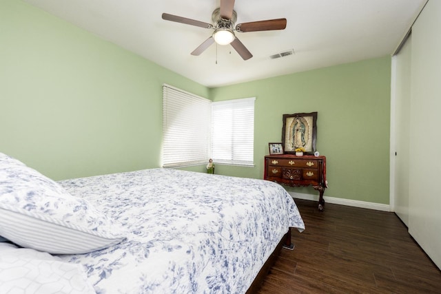 bedroom with ceiling fan and dark hardwood / wood-style flooring