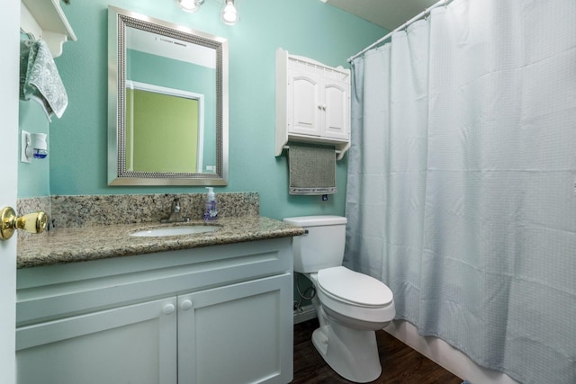 bathroom with vanity, wood-type flooring, and toilet