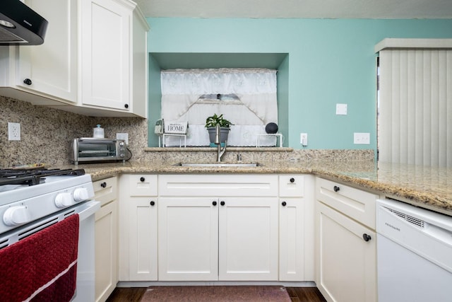 kitchen with sink, extractor fan, tasteful backsplash, white appliances, and white cabinets