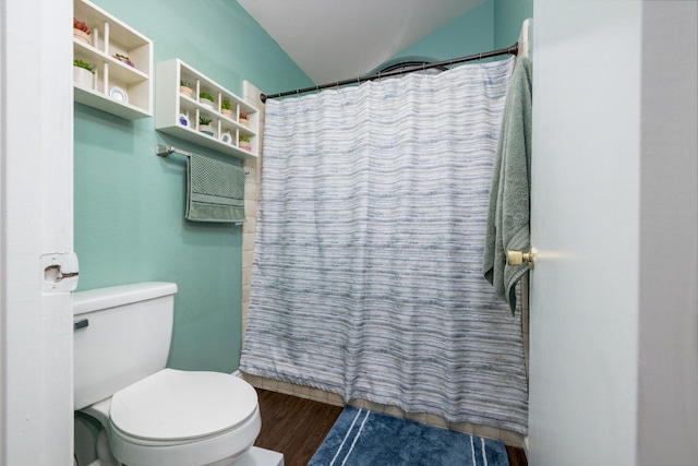 bathroom featuring a shower with curtain, hardwood / wood-style flooring, and toilet