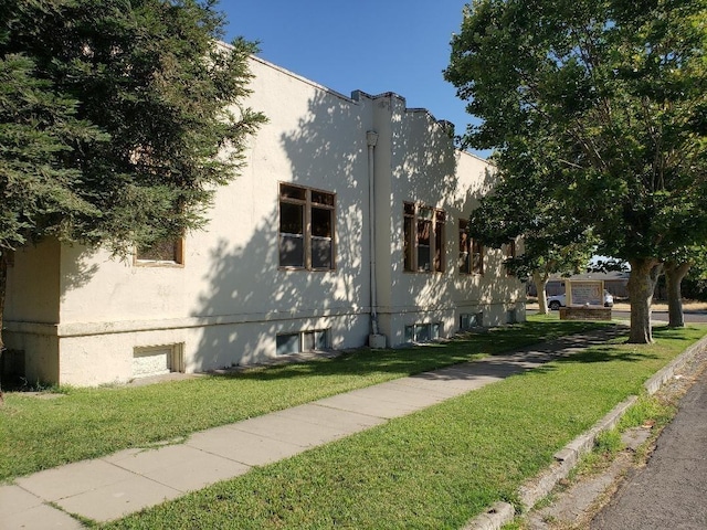 view of property exterior with a yard