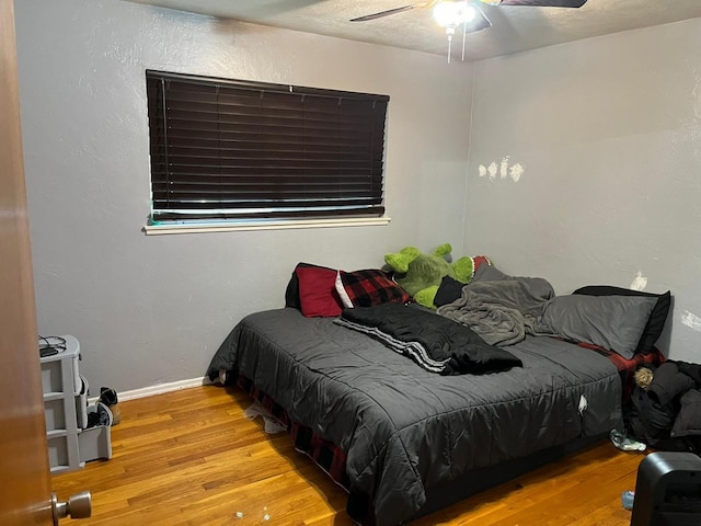 bedroom with ceiling fan and light hardwood / wood-style flooring