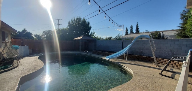 view of swimming pool featuring a water slide