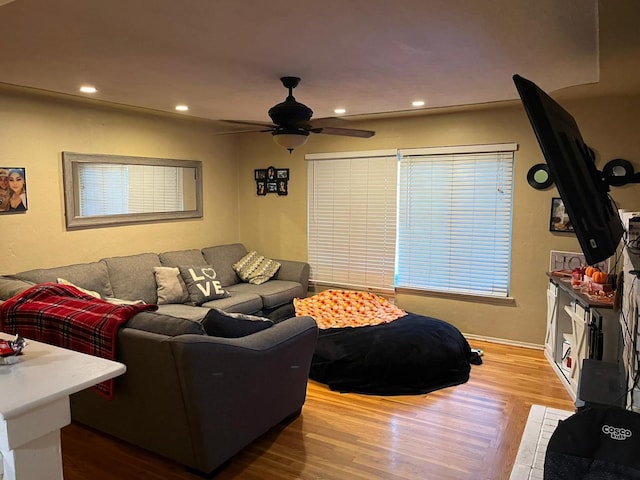 living room featuring ceiling fan and wood-type flooring