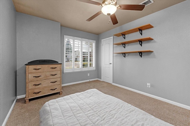 bedroom featuring light colored carpet, ceiling fan, and a closet