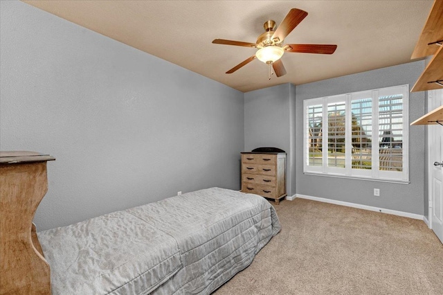 bedroom featuring light carpet and ceiling fan