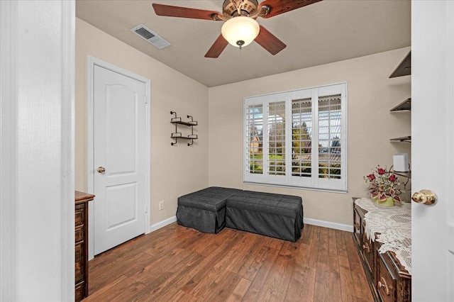 sitting room with ceiling fan and hardwood / wood-style floors