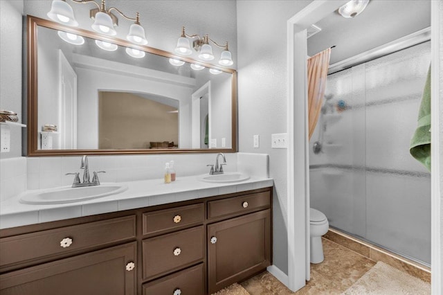 bathroom featuring vanity, toilet, and walk in shower