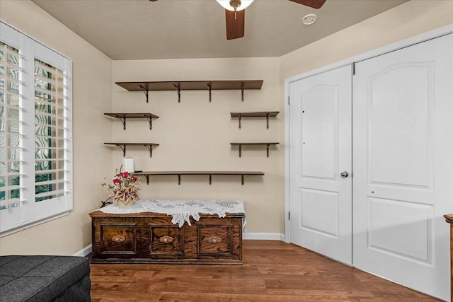 interior space featuring hardwood / wood-style flooring, a textured ceiling, and ceiling fan