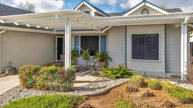 doorway to property with a pergola