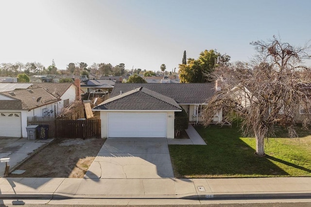 ranch-style home with a garage and a front yard