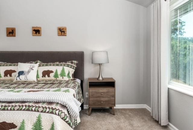 bedroom featuring light colored carpet