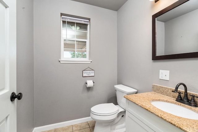 bathroom featuring vanity, toilet, and tile patterned flooring