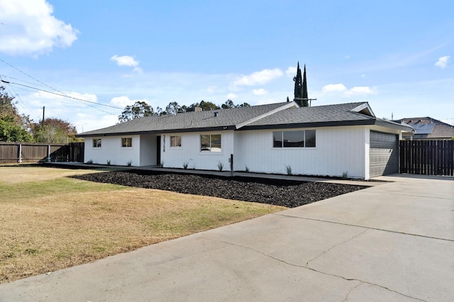 view of front of home featuring a garage and a front lawn