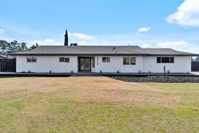 rear view of house with a lawn