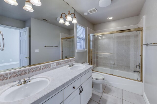 full bathroom featuring tile patterned flooring, enclosed tub / shower combo, vanity, and toilet