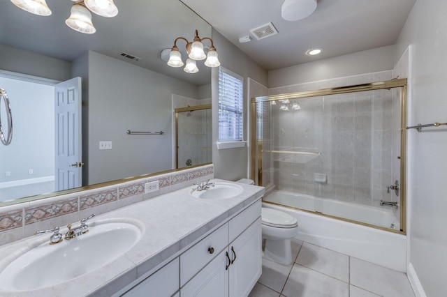 full bathroom with vanity, tile patterned floors, toilet, and combined bath / shower with glass door