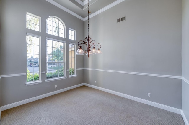 carpeted empty room with an inviting chandelier, crown molding, and a towering ceiling