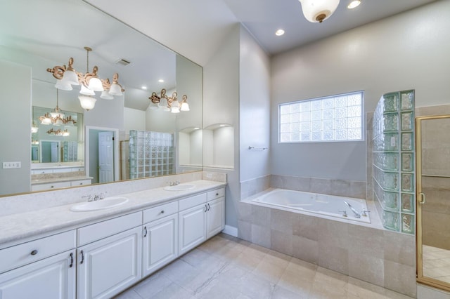 bathroom with plus walk in shower, a notable chandelier, and vanity