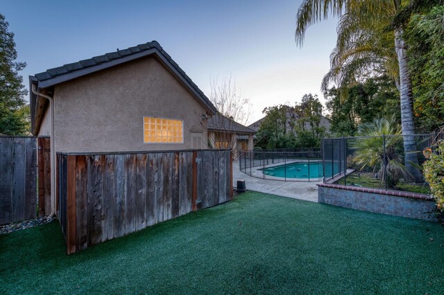 view of pool featuring a yard