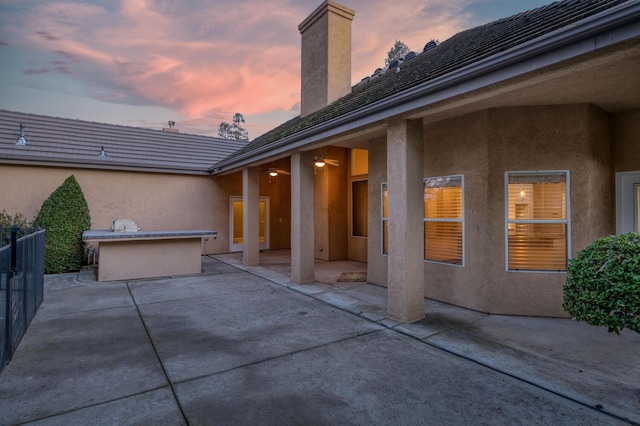 view of patio terrace at dusk