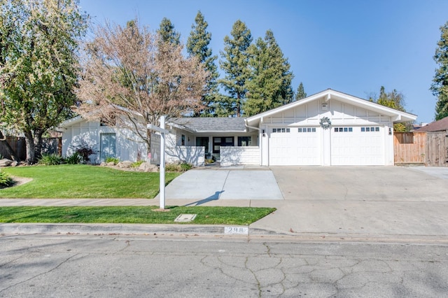 single story home featuring a garage and a front lawn