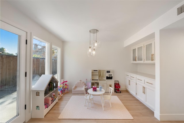 interior space with a notable chandelier and light hardwood / wood-style flooring