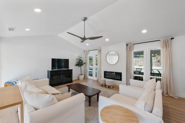 living room with lofted ceiling, light hardwood / wood-style flooring, and ceiling fan