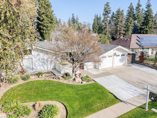 view of front of home featuring a garage and a front lawn