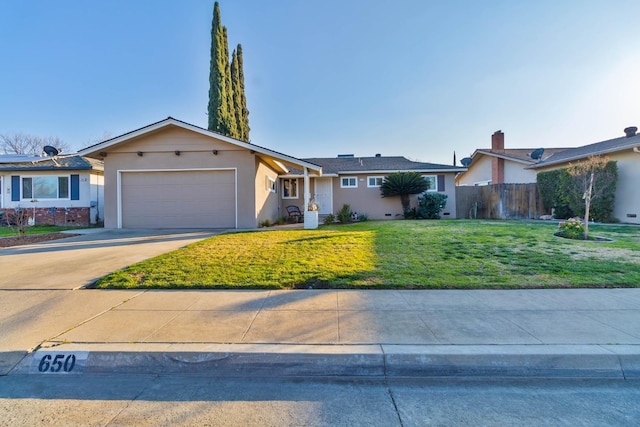 ranch-style home featuring a garage and a front lawn