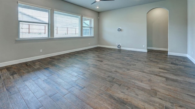 unfurnished room with dark wood-type flooring, ceiling fan, and plenty of natural light