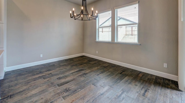 unfurnished dining area featuring dark hardwood / wood-style flooring and a chandelier