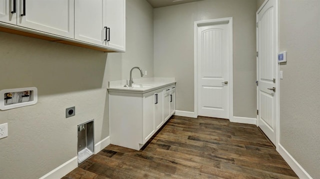 laundry area featuring sink, cabinets, dark hardwood / wood-style flooring, hookup for a washing machine, and electric dryer hookup